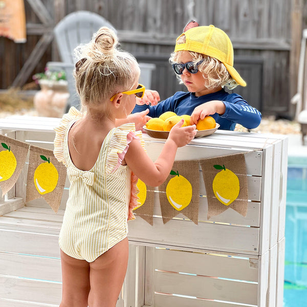 RuffleButts Toddler Seersucker One Piece with Roshambo Yellow Sunglasses - HoneyBug 